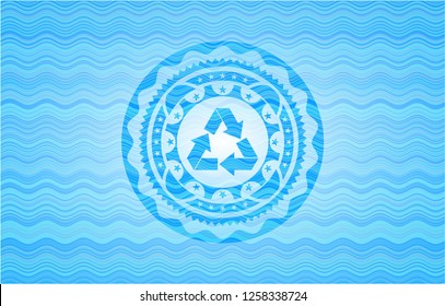 recycle icon inside light blue water wave style emblem.
