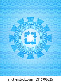 recycle icon inside light blue water emblem background.