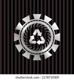 recycle icon inside silver badge or emblem. 