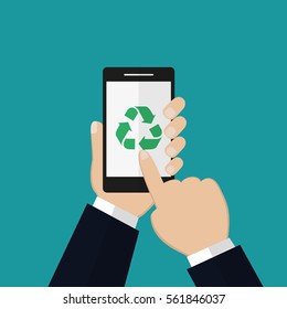 Recycle sign on smartphone screen.Hands of a man using a phone showing a recycle sign