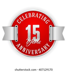 Red 15 years anniversary badge with silver border and ribbon