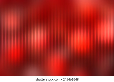 Red abstract blur colored background with defocused vertical rays of light.
