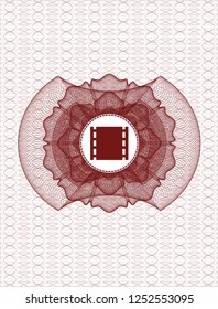 Red abstract linear rosette with film icon inside