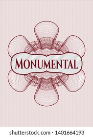 Red abstract rosette with text Monumental inside