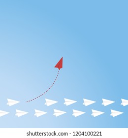 Red airplane changing direction and white ones. New idea, change, trend, courage, creative solution, innovation and unique way concept.