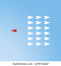 Red airplane changing direction and white ones. New idea, change, trend, courage, creative solution, innovation and unique way concept.