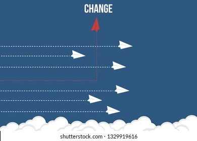 Red airplane changing direction and white ones. New idea, change, trend, courage, creative solution, innovation and unique way concept.