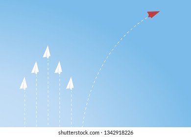 Red airplane changing direction and white ones. New idea, change, trend, courage, creative solution, innovation and unique way concept.