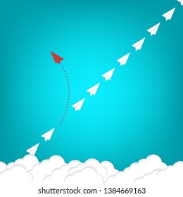 Red airplane changing direction and white ones. New idea, change, trend, courage, creative solution, innovation and unique way concept.