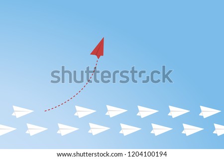 Red airplane changing direction and white ones. New idea, change, trend, courage, creative solution, innovation and unique way concept.