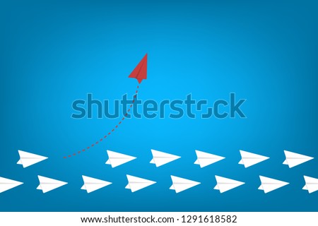 Red airplane changing direction and white ones. New idea, change, trend, courage, creative solution, innovation and unique way concept.