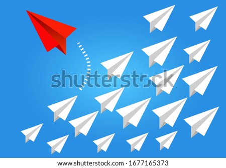 Red airplane changing direction from white ones. New idea, change, trend, courage, creative solution, innovation and unique way concept.