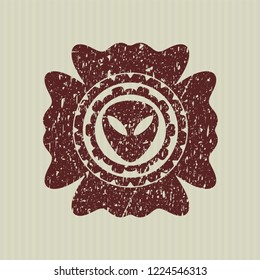 Red alien icon inside distress rubber seal with grunge texture
