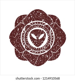 Red alien icon inside distressed rubber stamp with grunge texture