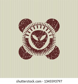 Red alien icon inside rubber grunge texture seal