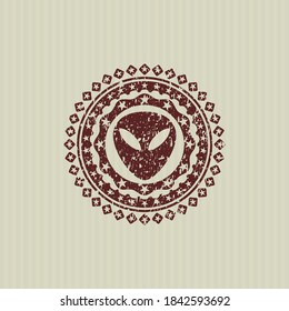 Icono alienígena rojo con textura de sello de goma. 