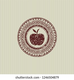 Red apple icon inside distress with rubber seal texture