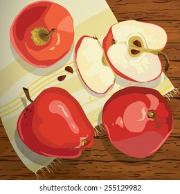 red apples on a wooden table napkin with pattern