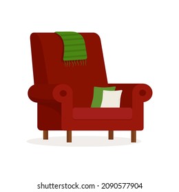 Red armchair with pillows isolated on a white background.