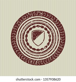 Red armor icon inside distress rubber grunge stamp