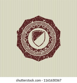 Red armor icon inside distressed rubber grunge stamp