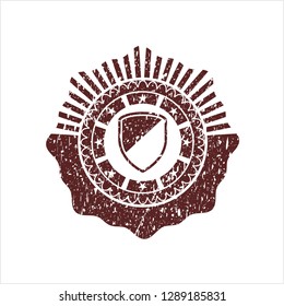 Red armor icon inside distressed rubber stamp