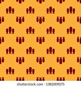 Red Aviation bombs icon isolated seamless pattern on brown background. Rocket bomb flies down. Flat design. Vector Illustration