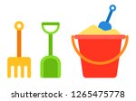 Red baby bucket with sand and shovel and rake for a sandbox next to it vertically vector flat icon isolated on white