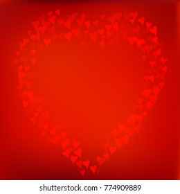 Red background with heart made of defocused blurred hearts.