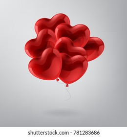 Red balloons in form of heart on light background