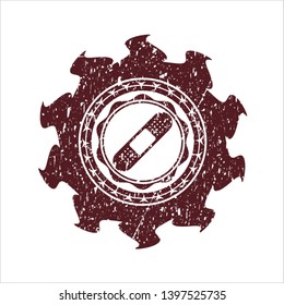 Red bandage plaster icon inside distress rubber seal