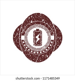 Red battery charging icon inside distress rubber grunge stamp