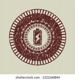 Red battery charging icon inside distress grunge seal