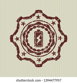 Red battery charging icon inside distressed rubber stamp
