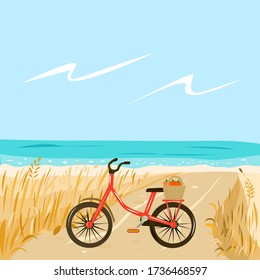 Red Bicycle on the beach by the sea with a basket of apples