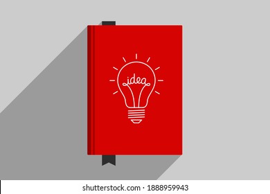 Red book with picture of light bulb at cover, personal book for writing genial ideas. Concept of generator of ideas, creative person, author creativity