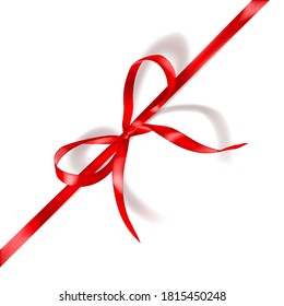 Red bow made of narrow ribbon with shadow on white background. Diagonal arrangement