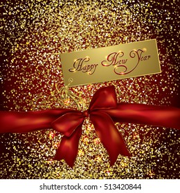 red bow and new year greeting card on a gold glittery background