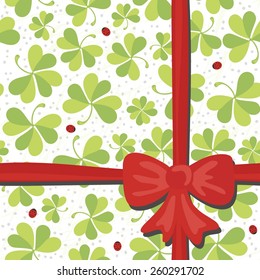 red bow on clover meadow with ladybugs gift wrap paper on white background