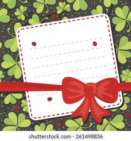 red bow on clover meadow with ladybugs blank card with place for your text on dark background