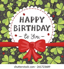 red bow on clover meadow with ladybugs birthday card with wishes in English on dark background