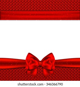 Red bow on red knitted background. Design Christmas card.