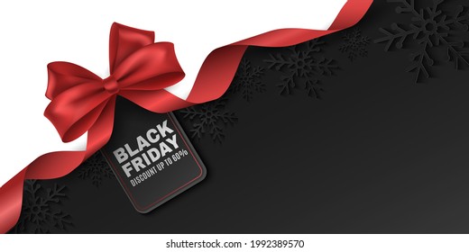 Red bow and ribbon with tag for Black Friday sale. Vector label to advertise your business promotions. Commercial discount event. Paper snowflakes on a dark background. EPS 10.