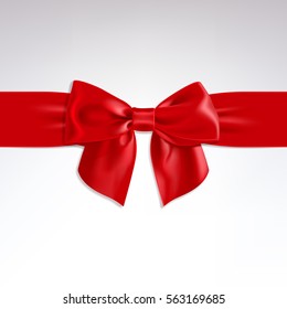 red bow of satin ribbon on a light background