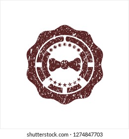 Red bow tie icon inside distressed rubber grunge seal