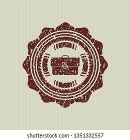 Red briefcase icon inside distressed rubber stamp with grunge texture