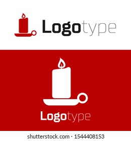 Red Burning candle in candlestick icon isolated on white background. Old fashioned lit candle. Cylindrical candle stick with burning flame. Logo design template element. Vector Illustration