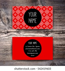 Red Business card template with creative white linear arabic texture on wooden background