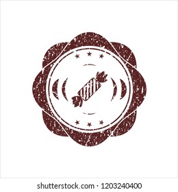 Red candy icon inside distress rubber stamp with grunge texture