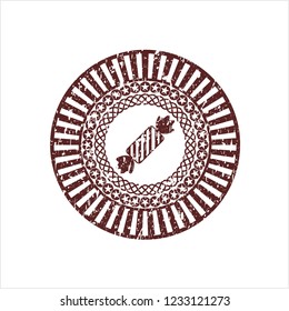 Red candy icon inside distressed grunge stamp